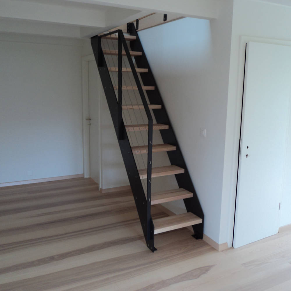 Escalier avec limons en stratifié, balustrade en métal et câbles en inox.